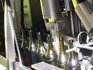 Bottles going down bottling line